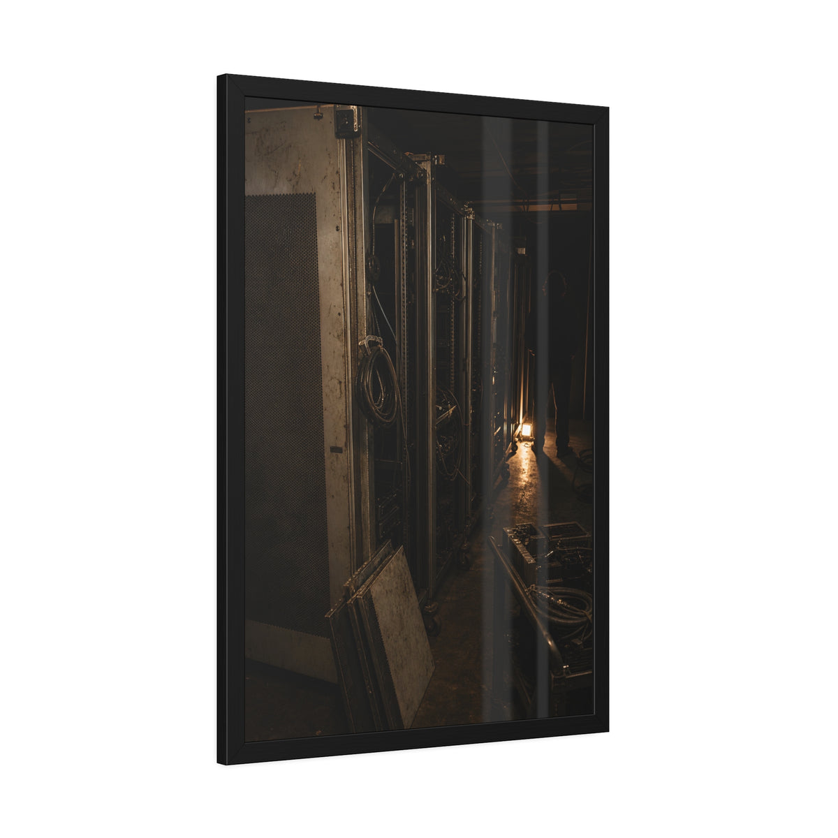 Open server racks in a dark room, a work lamp and a figure at the end. Garabaggio at the End of the Row by Garabaggio, framed fine art print hanging in a room.