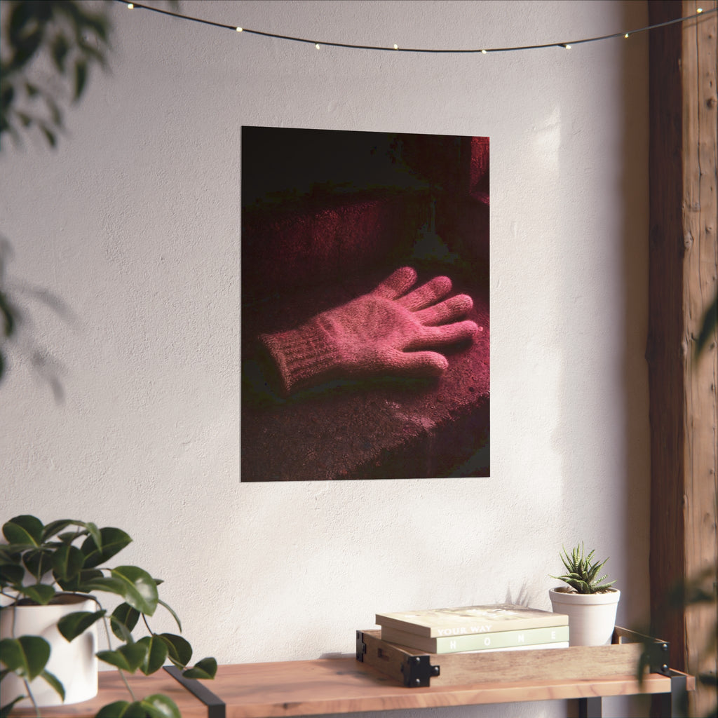A knitted glove lying flat on a concrete step under pink light. The Vigil in Pink Light by Garabaggio, fine art print hanging in a room.