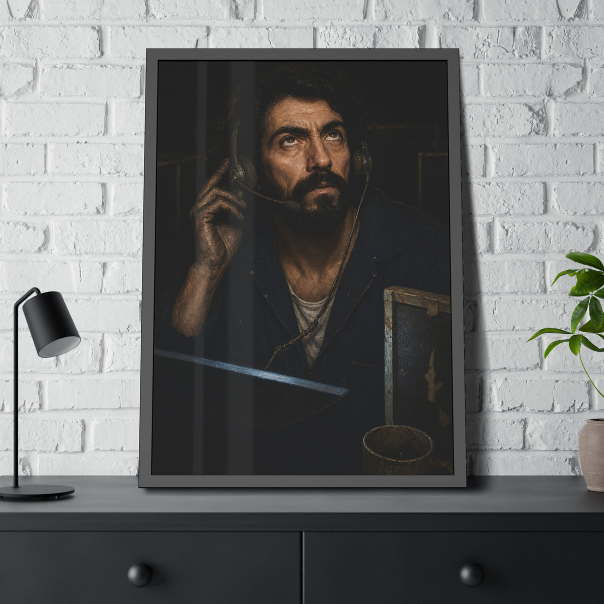 A man in a phone headset looks upward over the glow of a monitor. Garabaggio on Hold by Garabaggio, framed fine art print hanging in a room.