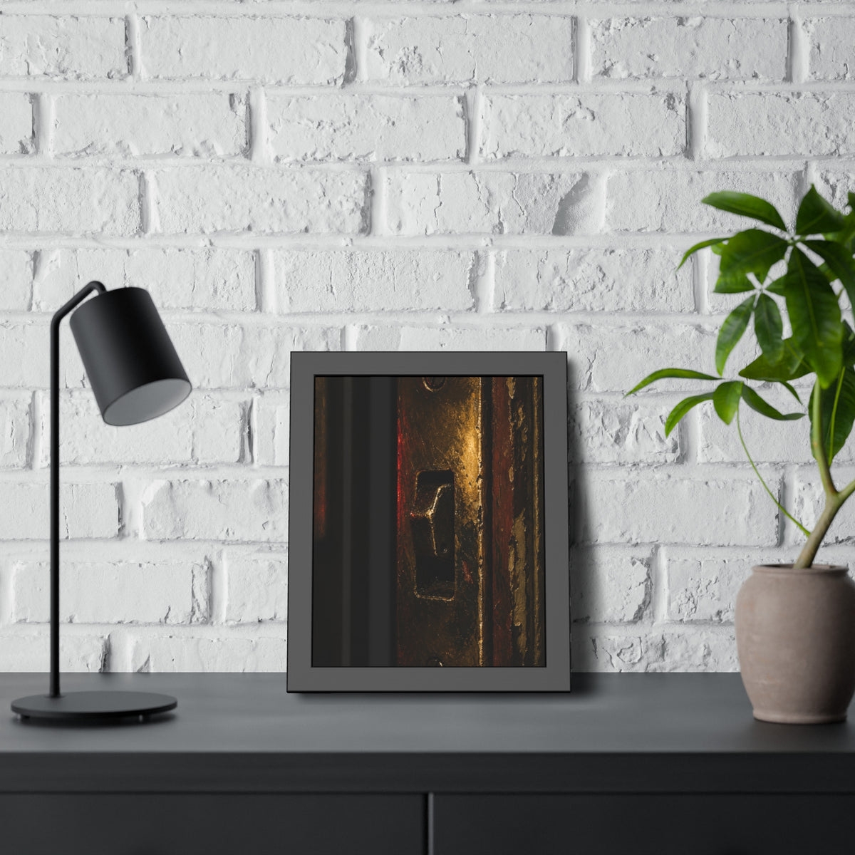 A brass door latch beside an intercom with a small red light. The Door Does Not Release by Garabaggio, framed fine art print hanging in a room.