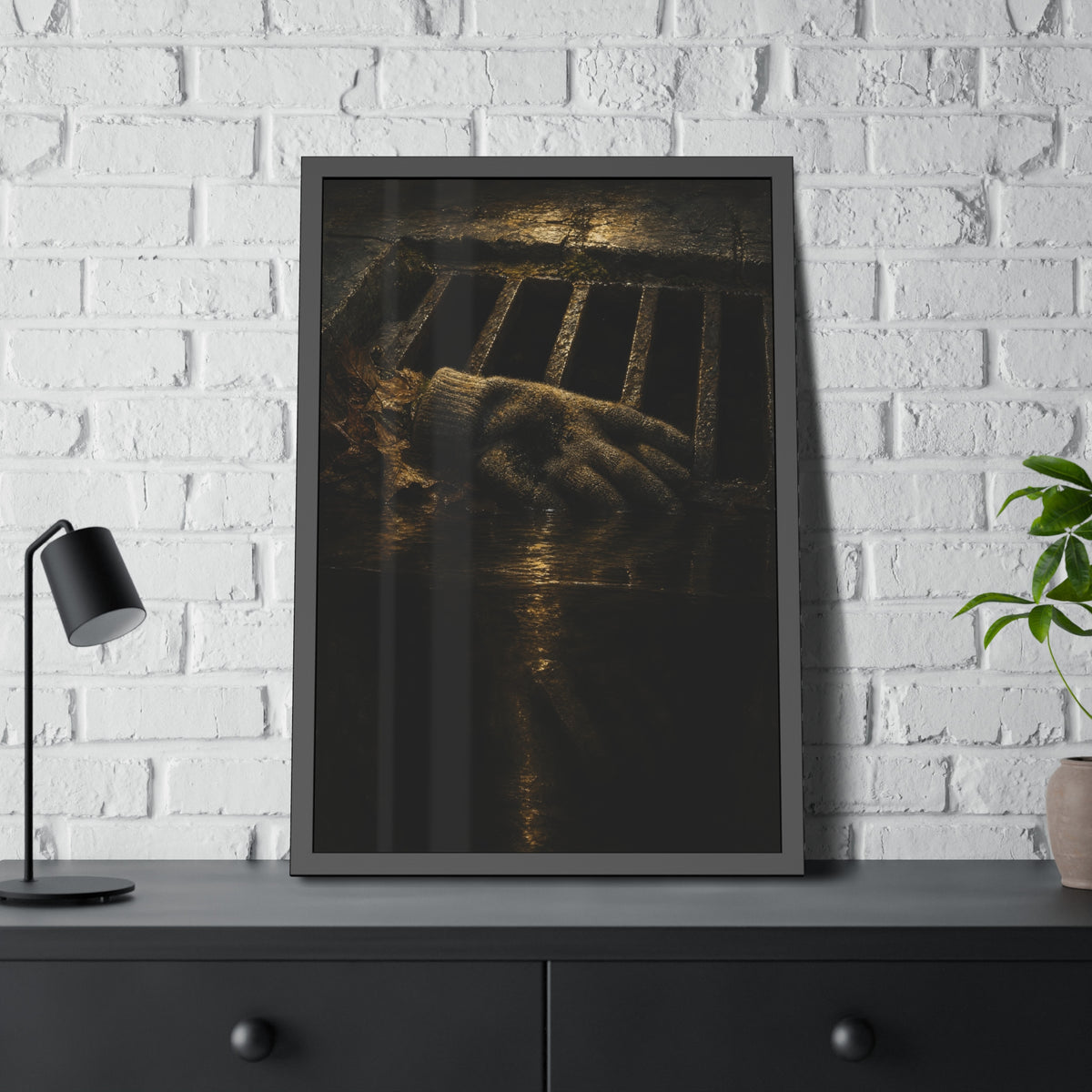 A single work glove on a storm drain grate above dark standing water. The Descent Into the Drain by Garabaggio, framed fine art print hanging in a room.