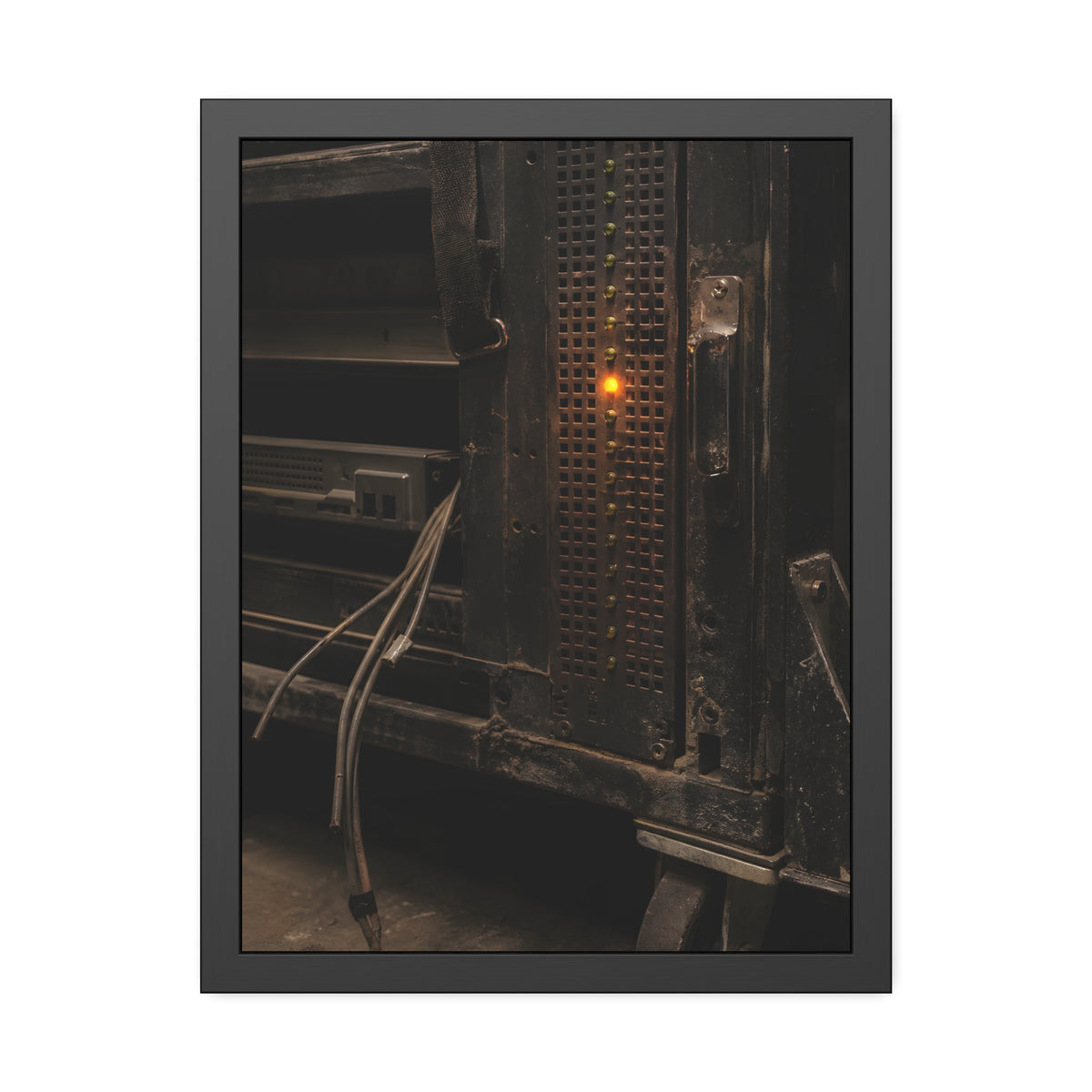 A single amber light among green LEDs on a grimy server rack. The Amber Fault by Garabaggio, framed fine art print, 18″ x 24″.