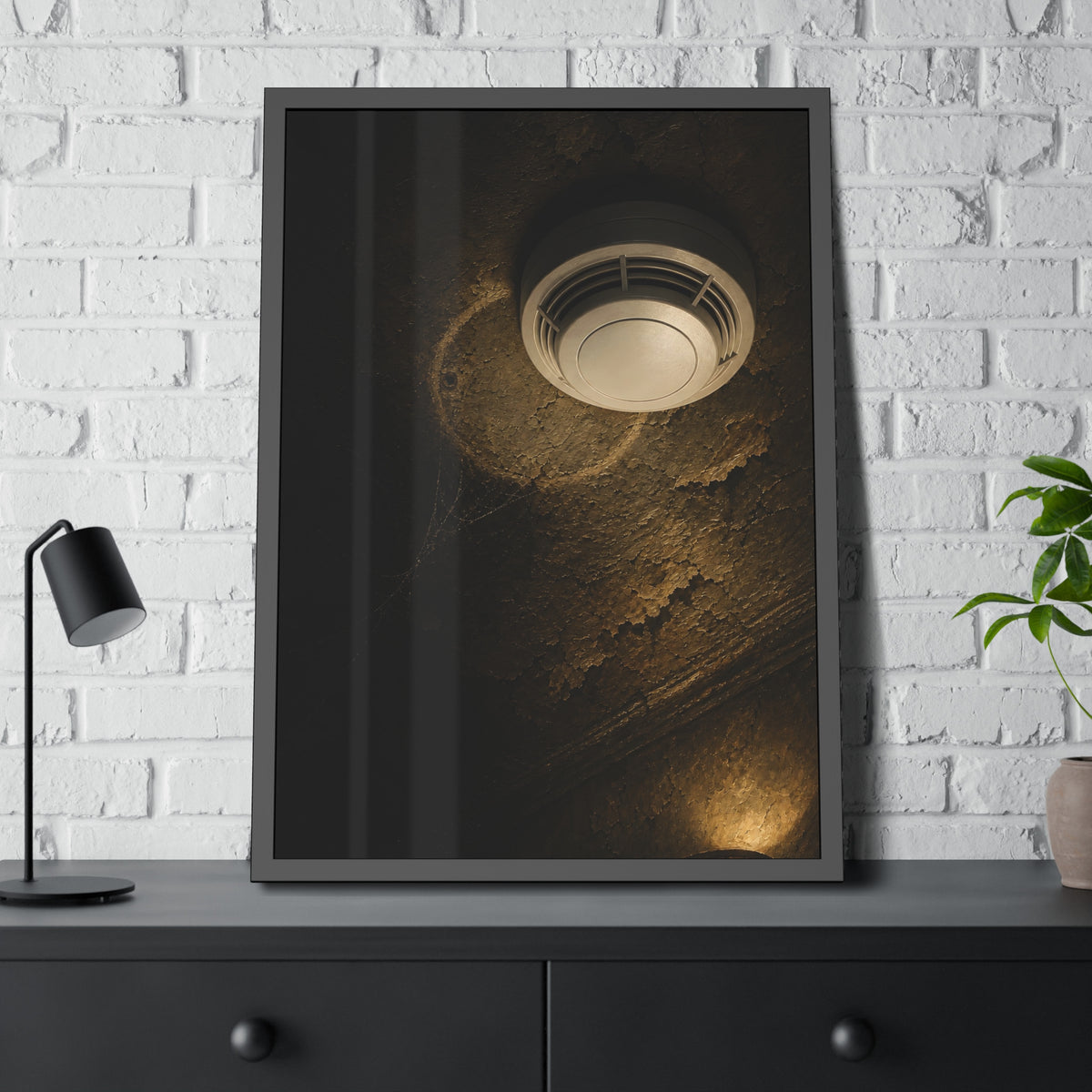 A new smoke detector on a stained ceiling next to an old mounting ring. The New Detector by Garabaggio, framed fine art print hanging in a room.