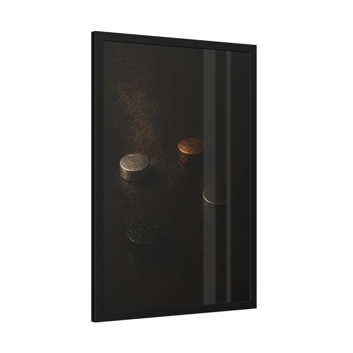 Four small metal discs on a dark scuffed surface in a narrow beam of light. Metals After the Song by Garabaggio, framed fine art print hanging in a room.
