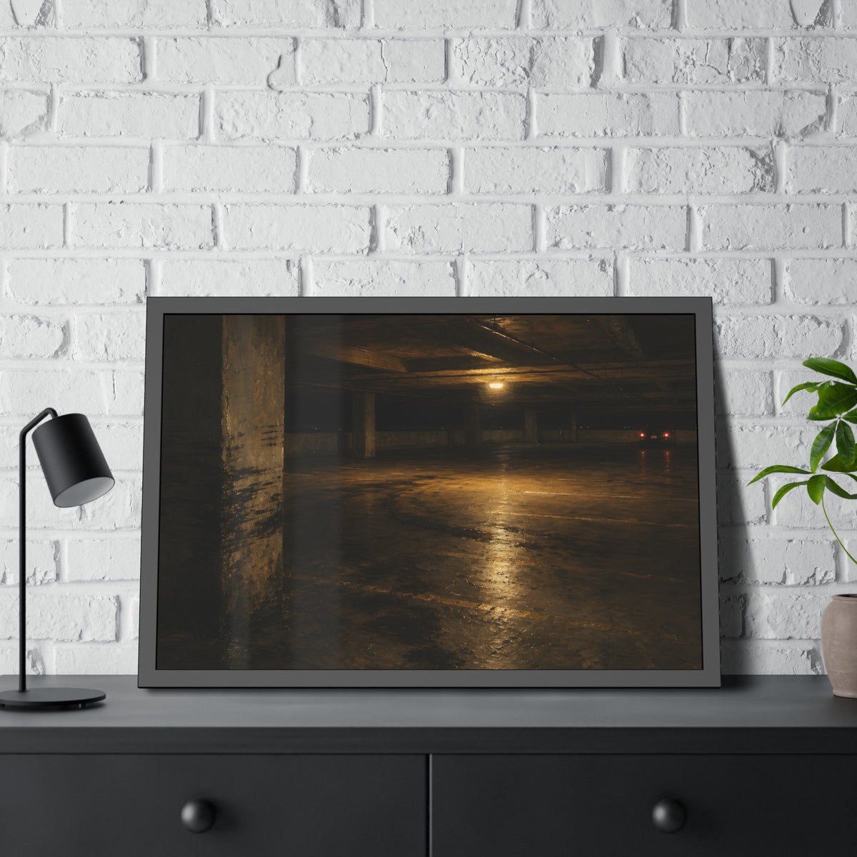 An empty concrete parking deck lit by one ceiling lamp, tail lights beyond. The Parking Garage, Level 4 by Garabaggio, framed fine art print hanging in a room.