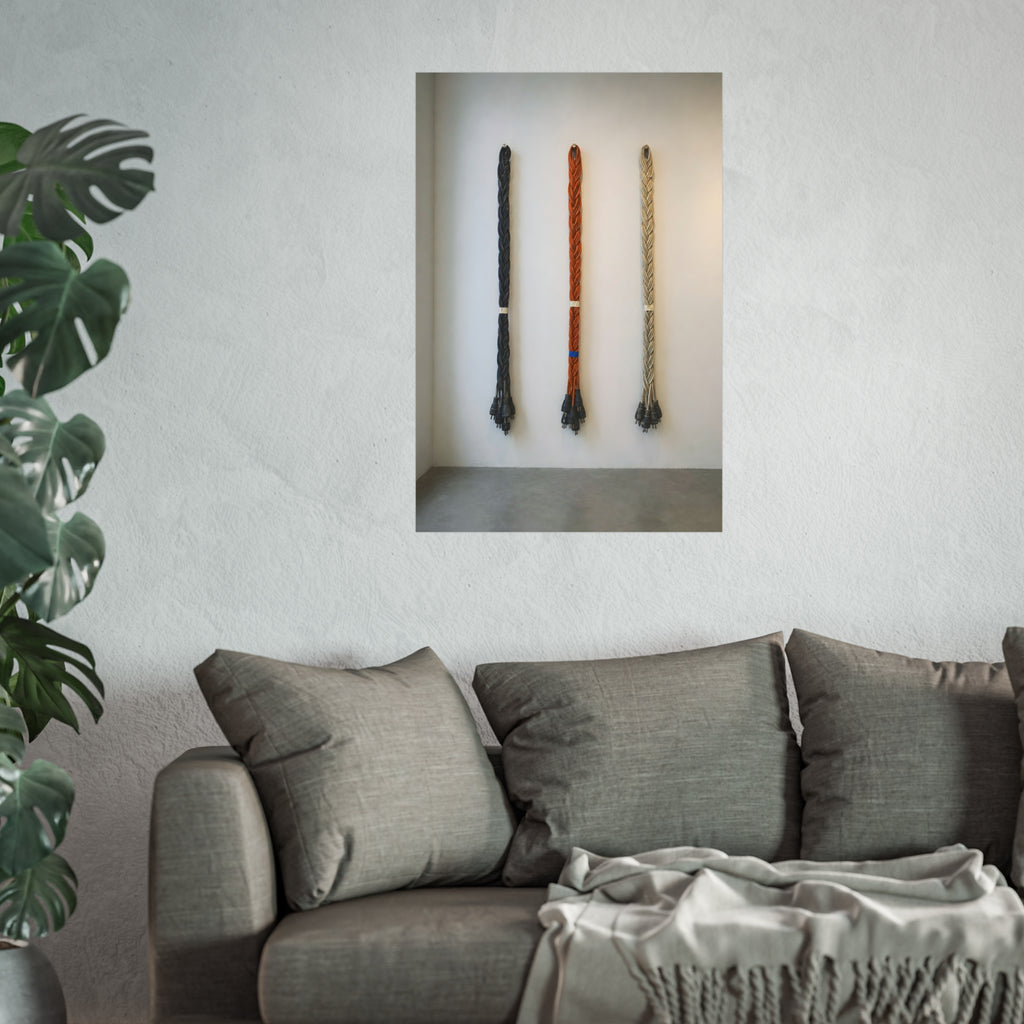 Three braided bundles of extension cords hung on a white gallery wall. The Braided Triptych by Garabaggio, fine art print hanging in a room.