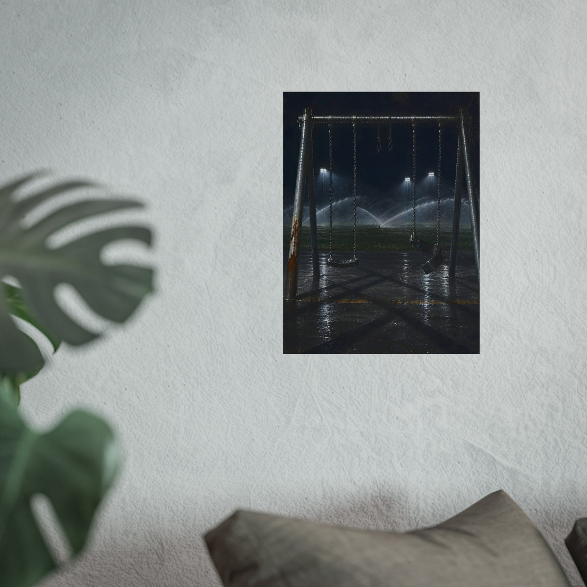 An empty swing set on wet asphalt, sprinklers arcing over the field. The Eleventh Hour: The Sprinklers by Garabaggio, fine art print hanging in a room.