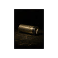 A corroded AA battery lying on a dark gritty surface in a single beam. The First Exhaustion by Garabaggio, fine art print, 12″ x 16″.