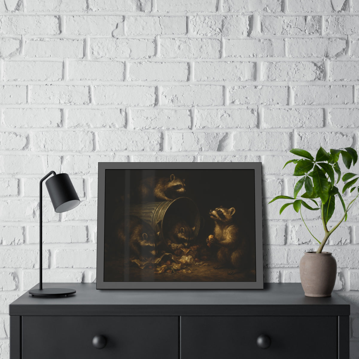 Four raccoons around a toppled metal trash can in the dark. The Last Bite by Garabaggio, framed fine art print hanging in a room.