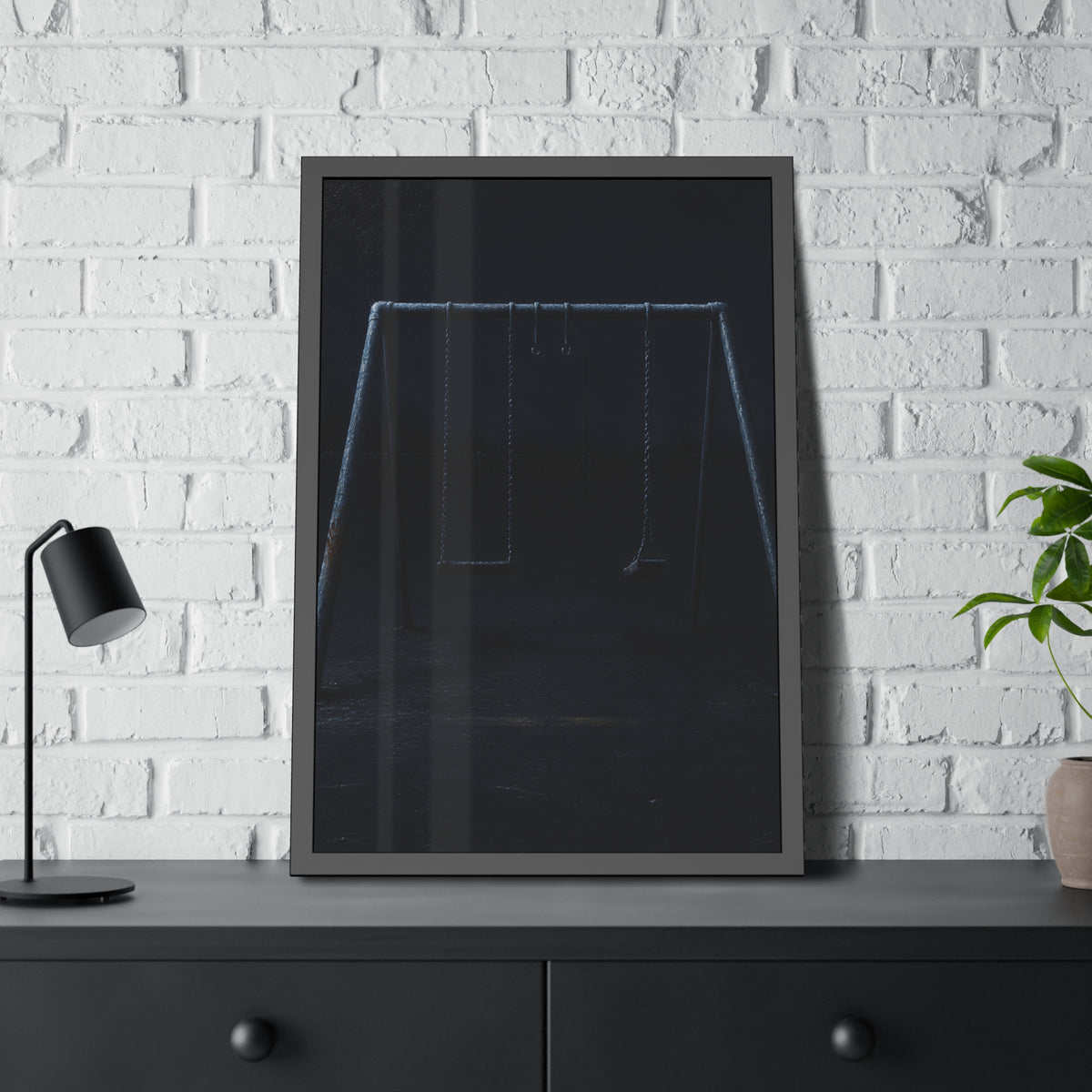 An empty swing set in near darkness with one seat twisted. The Fourth Hour: The Floodlights Cut by Garabaggio, framed fine art print hanging in a room.