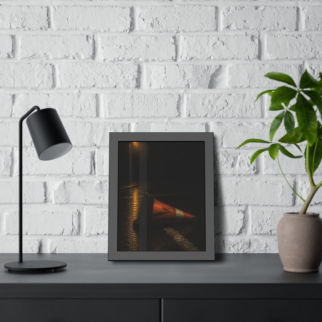 A toppled orange traffic cone on a wet road under a lone streetlight. The Taking by the Bumper by Garabaggio, framed fine art print hanging in a room.