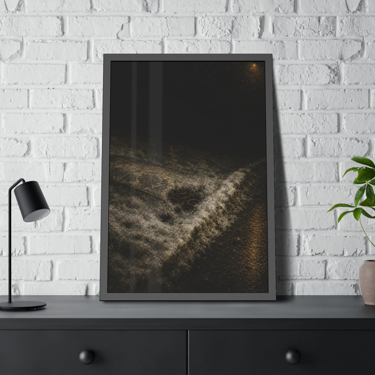 A discarded mattress half buried in snow, a distant streetlight behind. The White Burial by Garabaggio, framed fine art print hanging in a room.