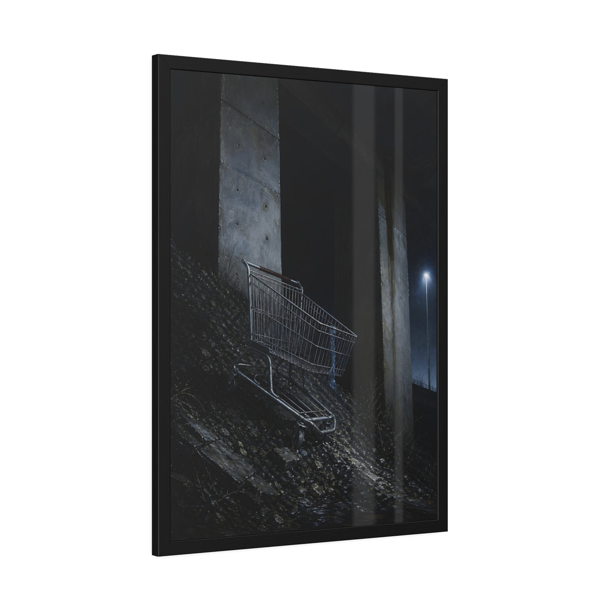 A shopping cart on a rocky slope under an overpass near a streetlamp. The Descent to the Underpass by Garabaggio, framed fine art print hanging in a room.