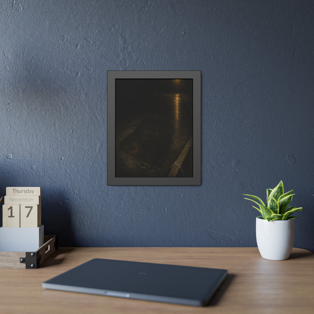 A rectangular stain on wet asphalt where something lay, under a streetlamp. The Stain After Removal by Garabaggio, framed fine art print hanging in a room.