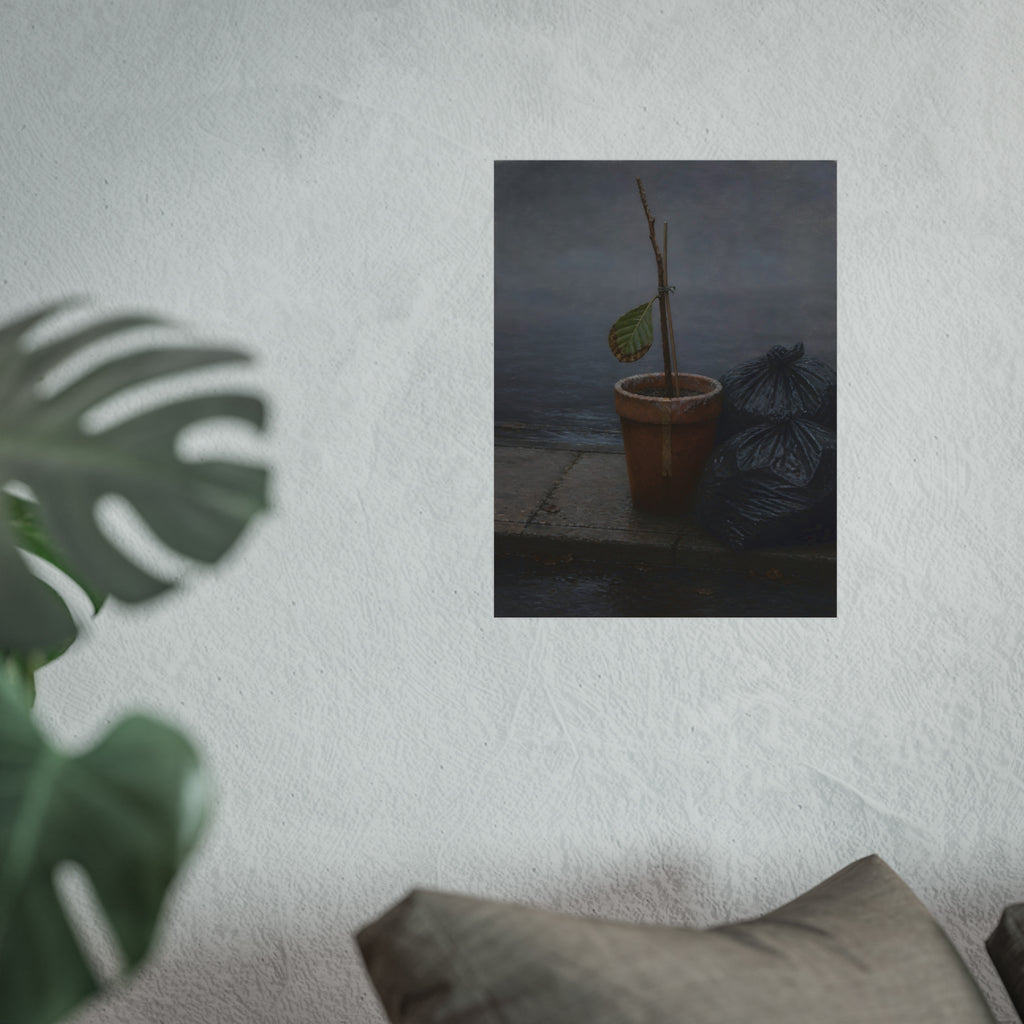 A potted dead twig with one leaf beside black garbage bags on a wet curb. The Curb on Tuesday by Garabaggio, fine art print hanging in a room.