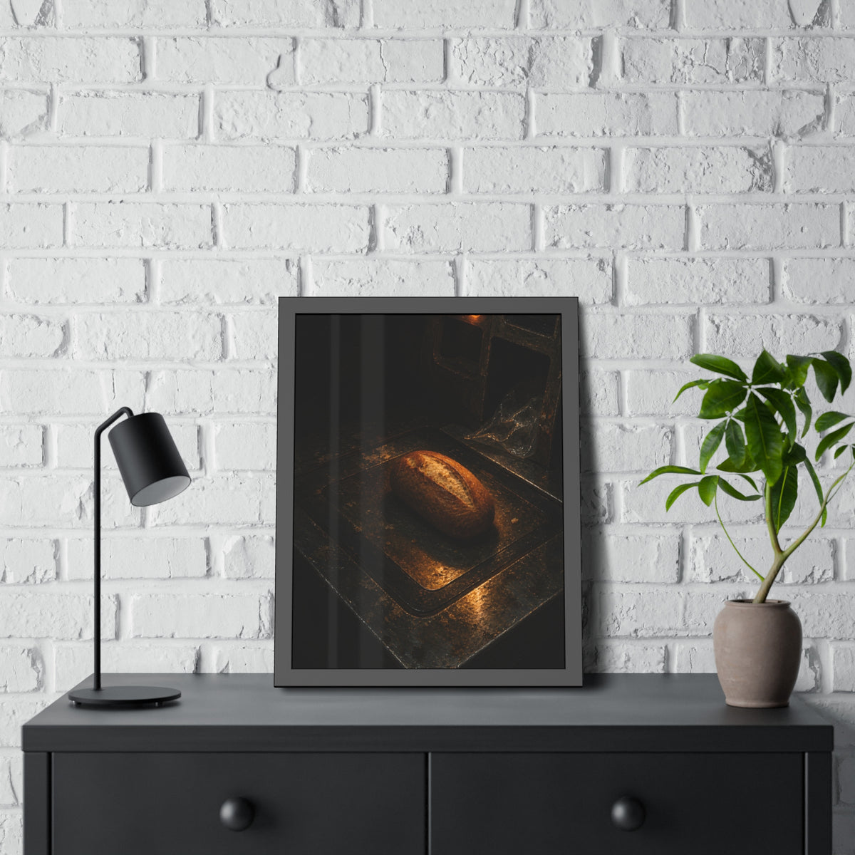 A loaf of bread alone on a dark self checkout weighing plate. The Witness at the Scale by Garabaggio, framed fine art print hanging in a room.