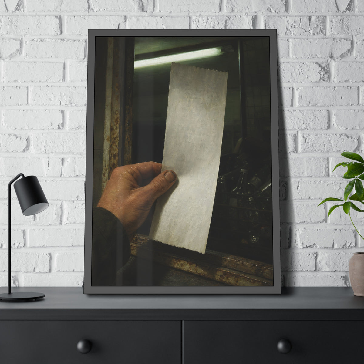 A hand holding a blank slip at a rusted counter window, bottles behind. The Receipt of Absolution by Garabaggio, framed fine art print hanging in a room.