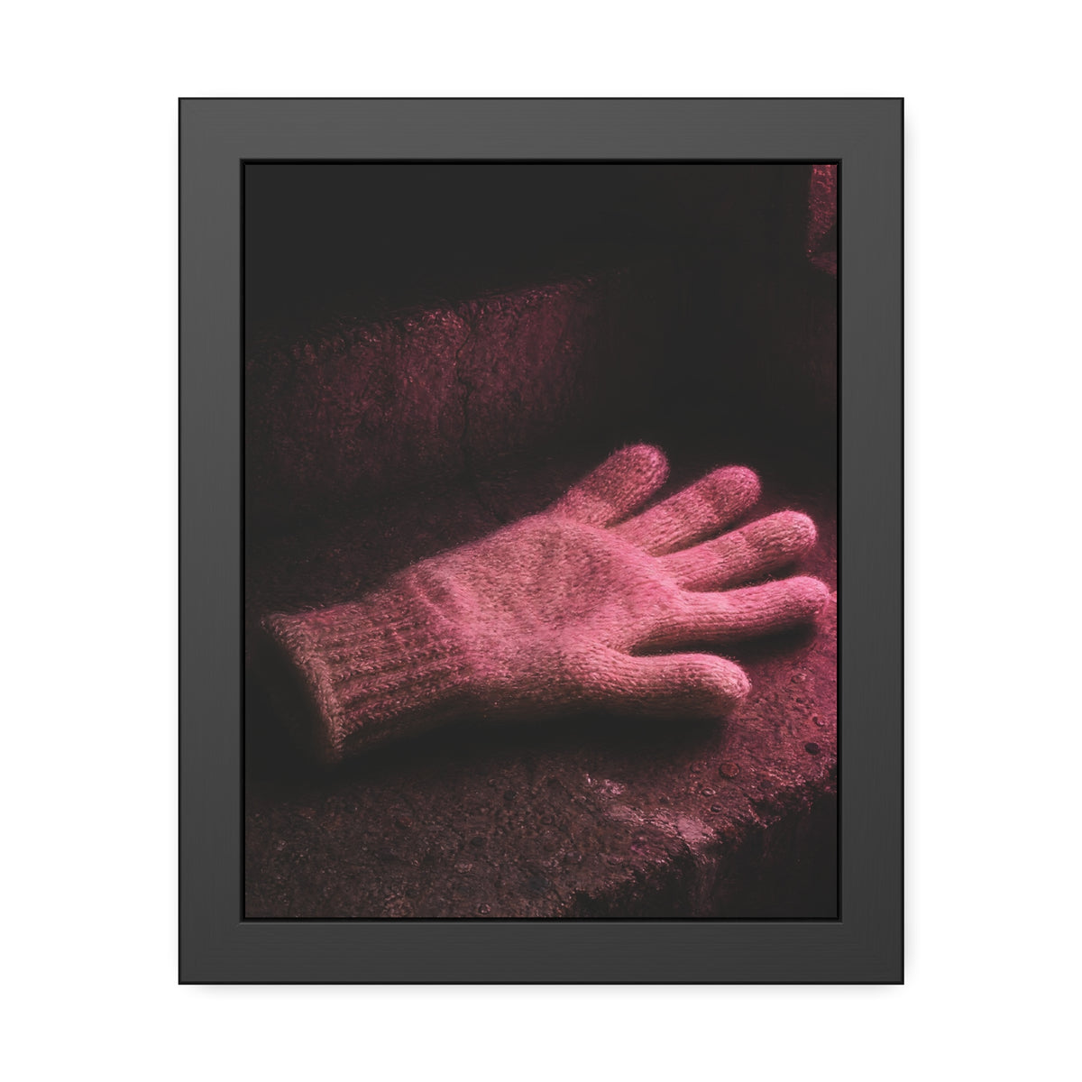 A knitted glove lying flat on a concrete step under pink light. The Vigil in Pink Light by Garabaggio, framed fine art print hanging in a room.