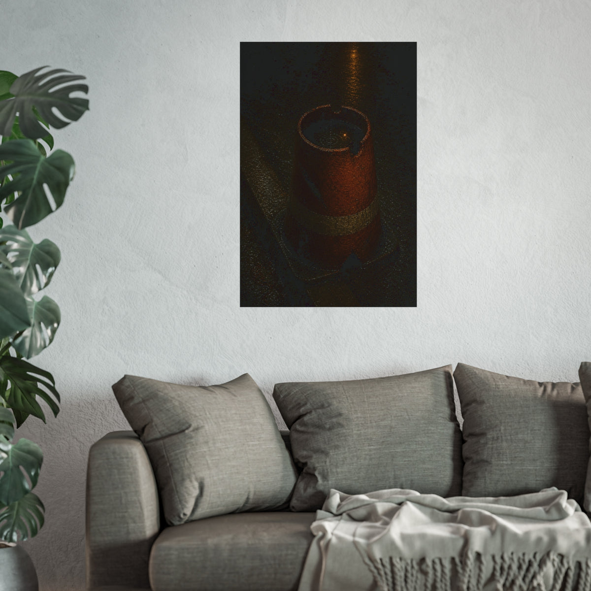 An upturned traffic cone holding rainwater at a wet curb under a lamp. The Cup of Rain by Garabaggio, fine art print hanging in a room.