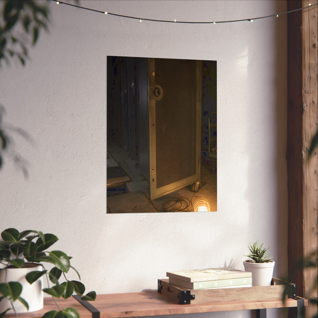 A perforated server rack door in a dark aisle lit by a floor work lamp. The Cold Aisle by Garabaggio, fine art print hanging in a room.