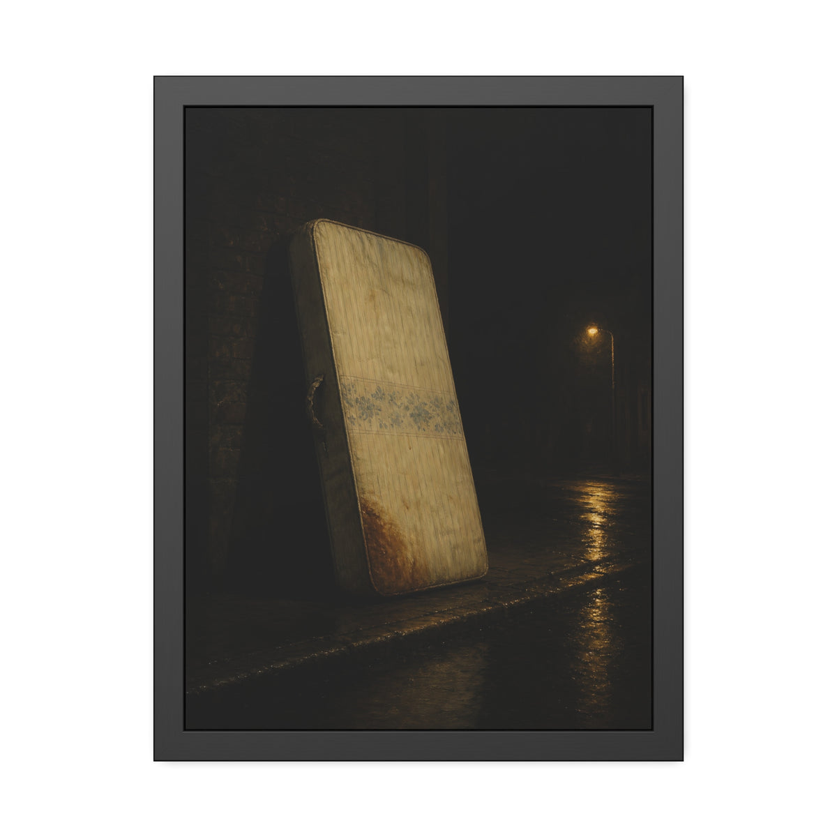 A stained mattress propped on a brick wall along a wet night street. The Presentation Against the Brick by Garabaggio, framed fine art print, 18″ x 24″.