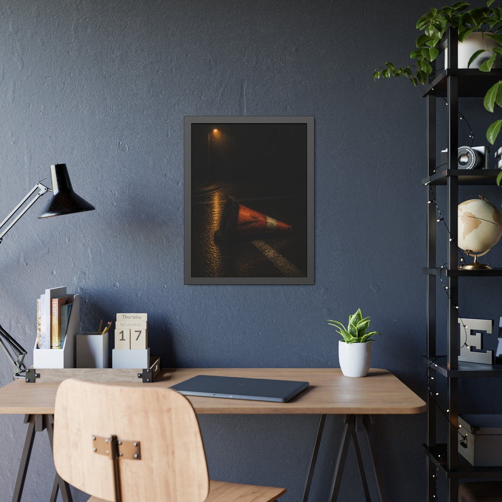 A toppled orange traffic cone on a wet road under a lone streetlight. The Taking by the Bumper by Garabaggio, framed fine art print hanging in a room.