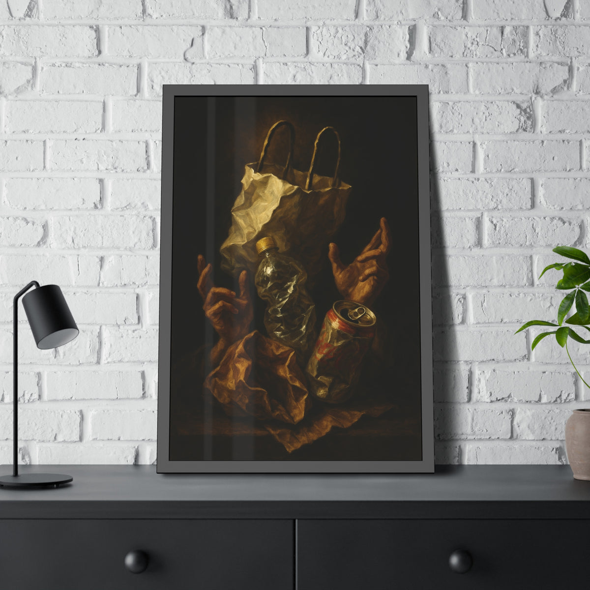 Two hands raised beside a paper bag, crushed bottle and dented can. The Assumption of the Discarded by Garabaggio, framed fine art print hanging in a room.