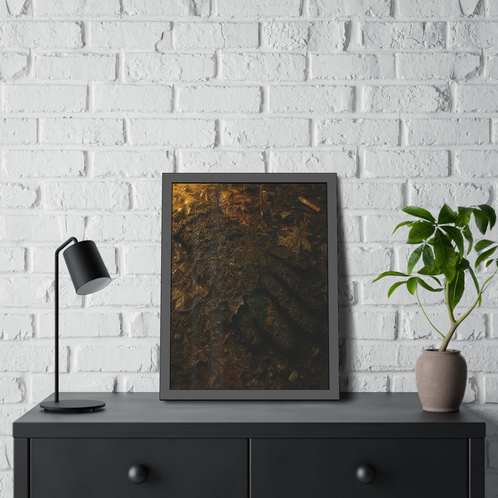 Wet mud and pressed oak leaves with a green scrap barely showing. The Reliquary of Mud and Leaf by Garabaggio, framed fine art print hanging in a room.