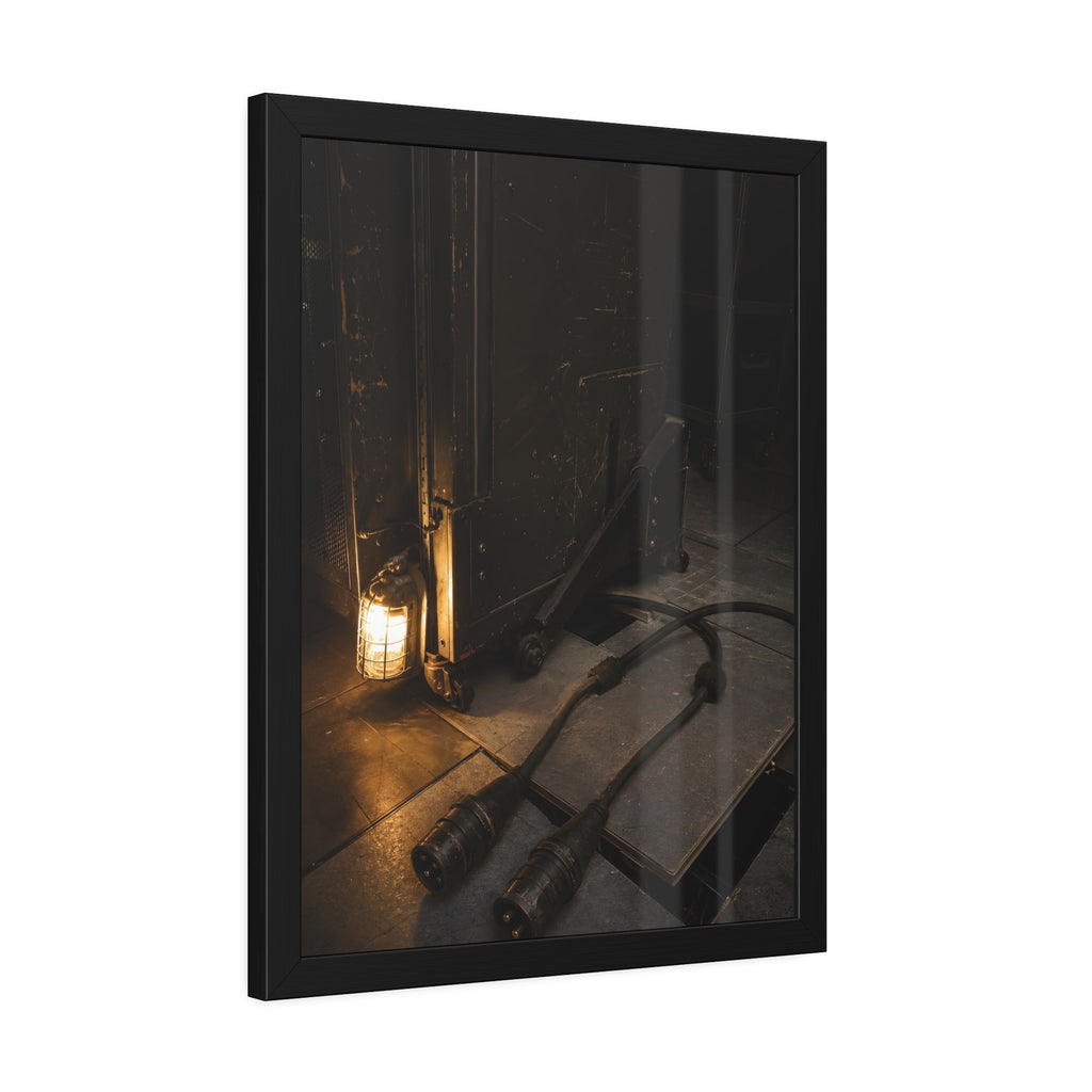 Two thick power cables unplugged on the floor beside a caged work lamp. The Redundant Power by Garabaggio, framed fine art print hanging in a room.