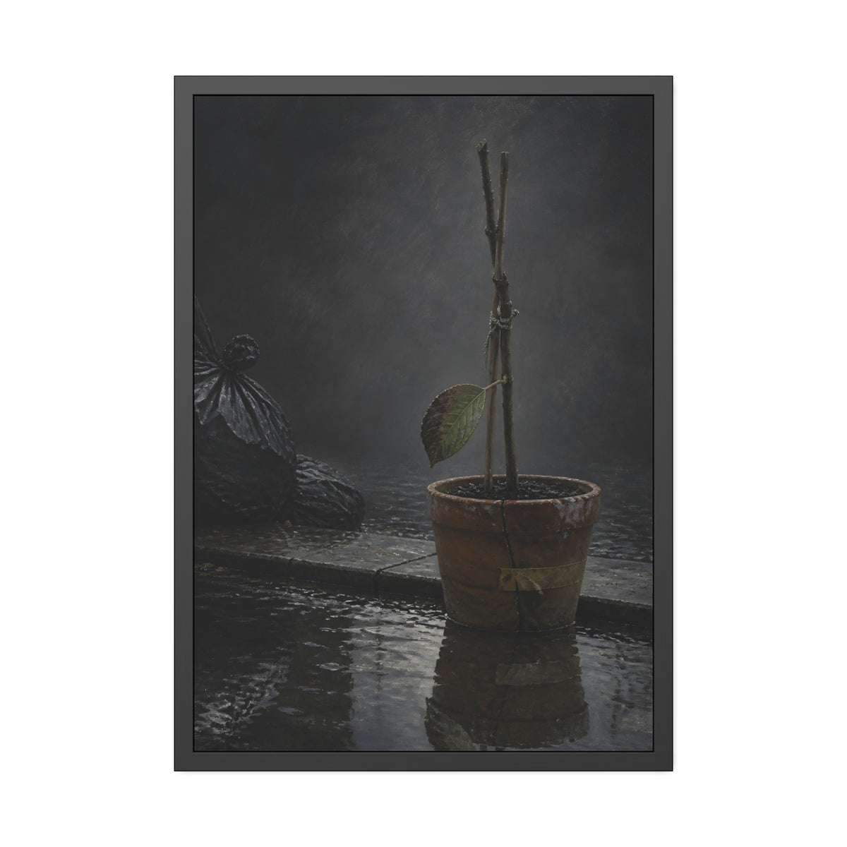 Bare tied stems in a clay pot on flooded pavement, one leaf remaining. The Grey Between by Garabaggio, framed fine art print, 28″ x 40″.