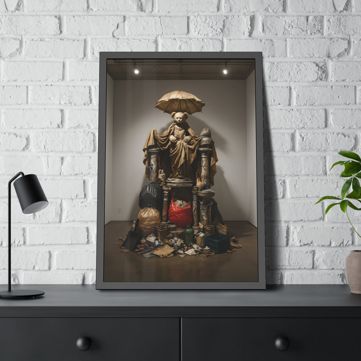 A teddy bear figure under an umbrella atop a pile of trash bags. Madonna of the Lost and Found by Garabaggio, framed fine art print hanging in a room.