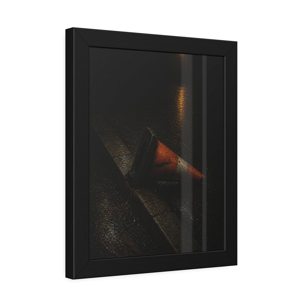 An orange traffic cone toppled on a wet curb under a distant streetlamp. The Dragging Through Rain by Garabaggio, framed fine art print hanging in a room.