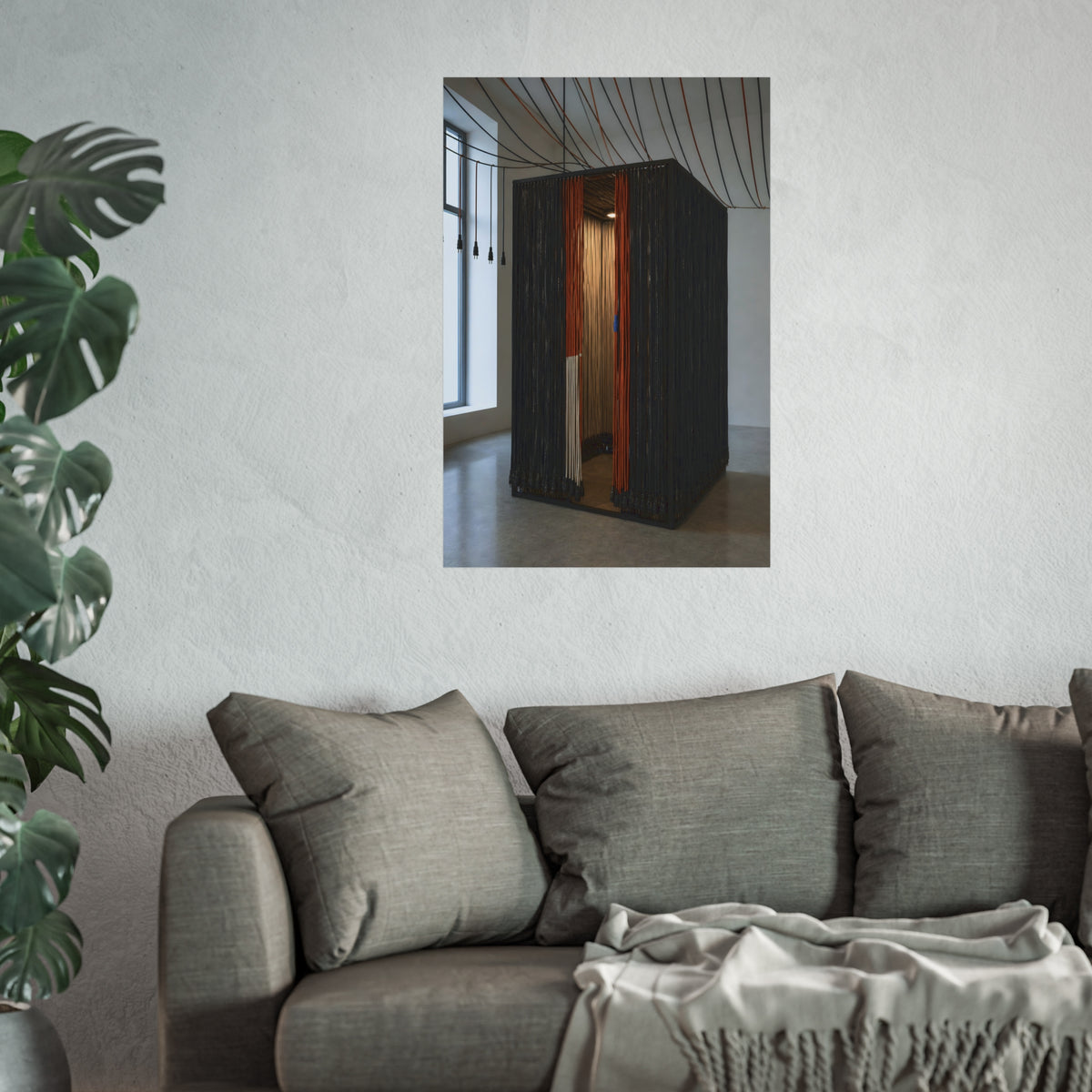 Booth walled with hanging power cords in a bare daylit room. Confessional for Current by Garabaggio, fine art print hanging in a room.