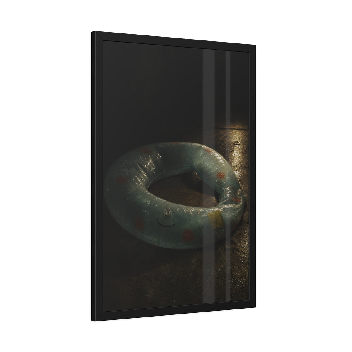 Deflated pool float ring on wet ground, lit from one side in the dark. After the Last Swim by Garabaggio, framed fine art print hanging in a room.