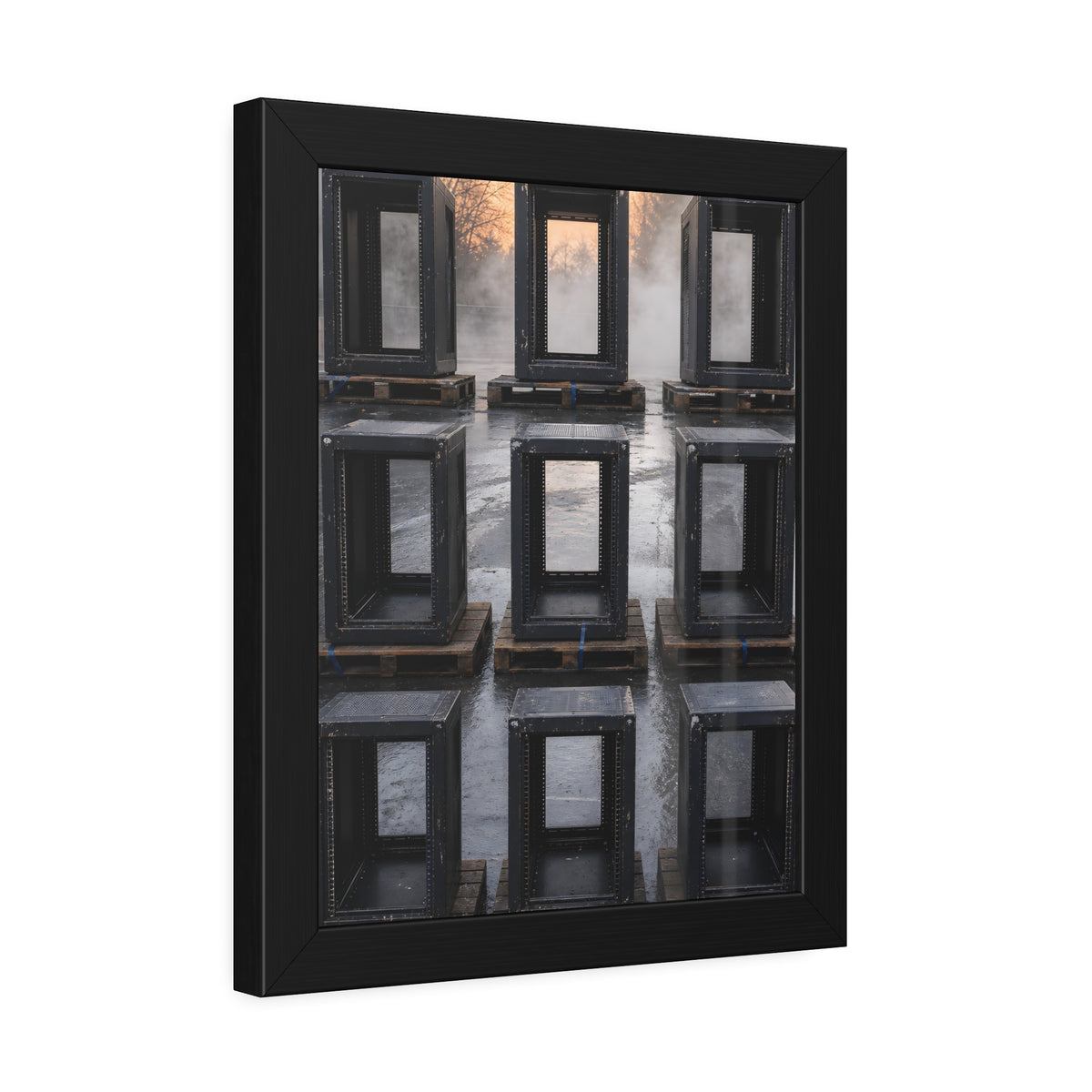 Nine empty black server racks on pallets in a wet lot at dawn. The Racks in the Morning Lot by Garabaggio, framed fine art print hanging in a room.