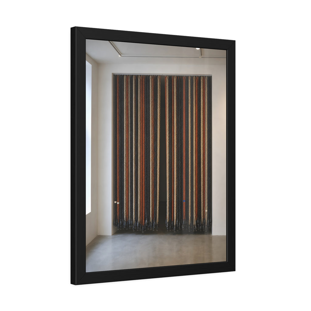 Hundreds of extension cords hung floor to ceiling across a bright white room. The Cord Curtain by Garabaggio, framed fine art print hanging in a room.