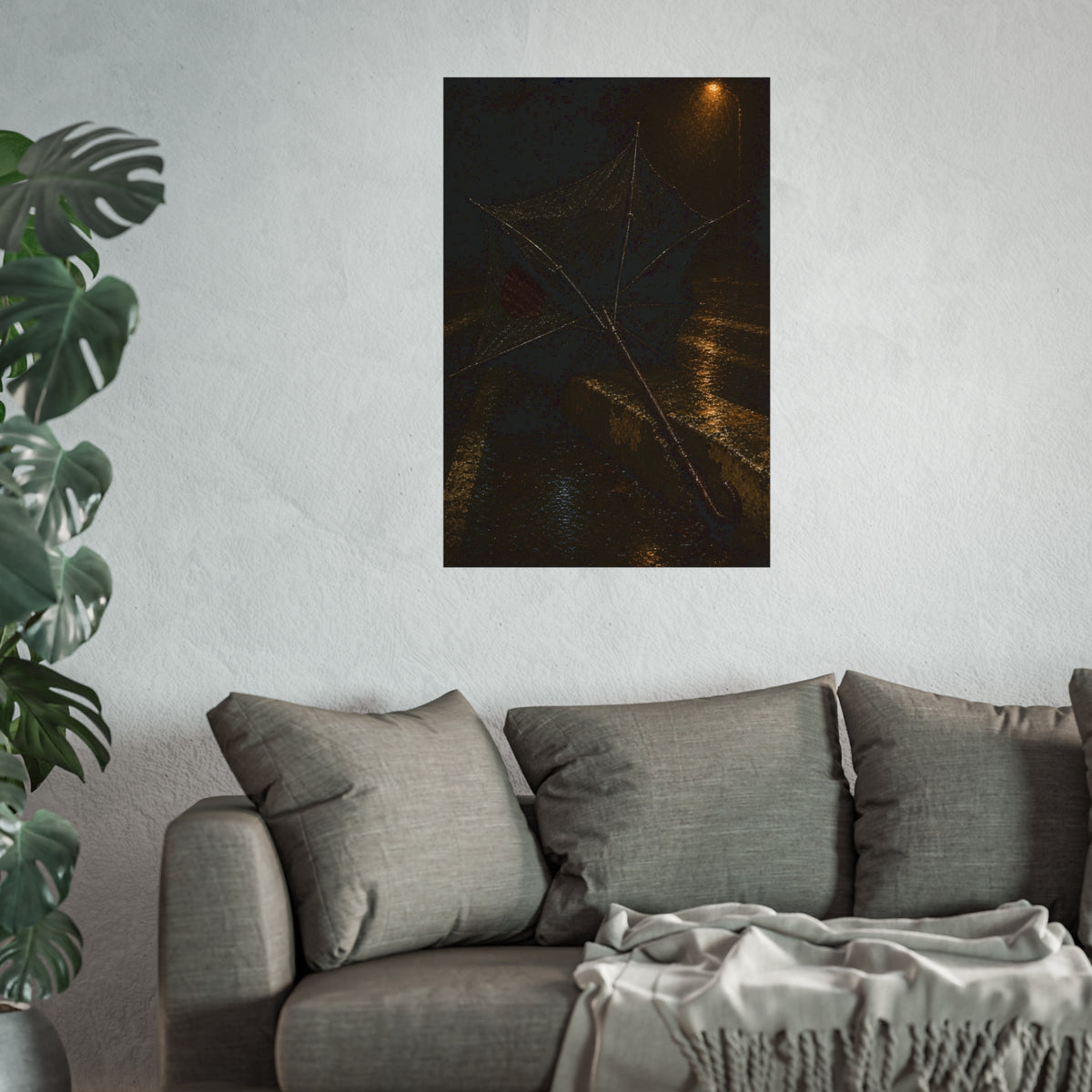 A broken umbrella inside out on a wet curb under a street lamp. The Inversion at the Median by Garabaggio, fine art print hanging in a room.
