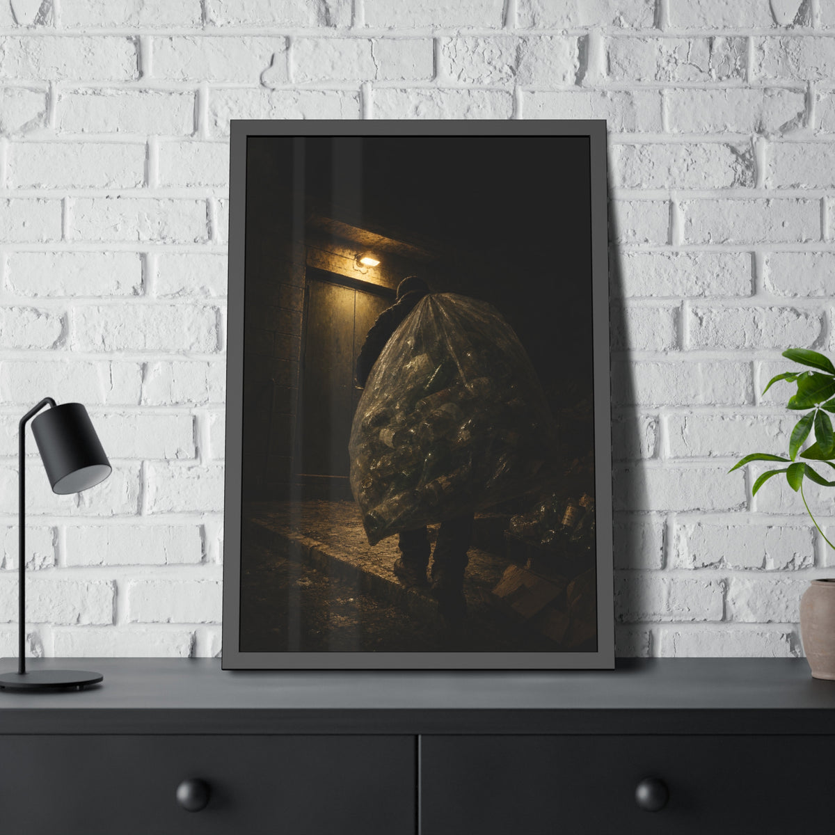 A man carrying a huge bag of bottles past a lit doorway at night. The Bag Carried Before Dawn by Garabaggio, framed fine art print hanging in a room.