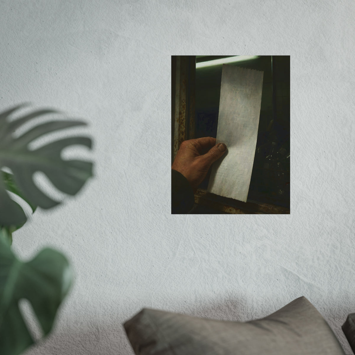 A hand holding a blank slip at a rusted counter window, bottles behind. The Receipt of Absolution by Garabaggio, fine art print hanging in a room.