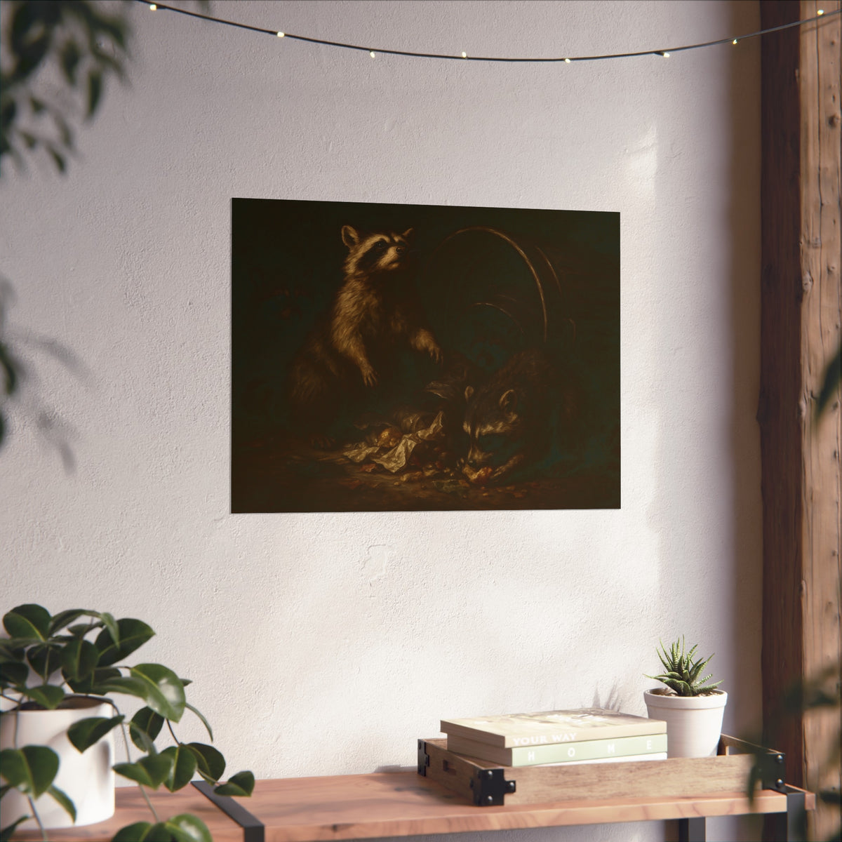Raccoons feeding on scraps around a tipped metal trash can in the dark. The Calling of St. Trash by Garabaggio, fine art print hanging in a room.