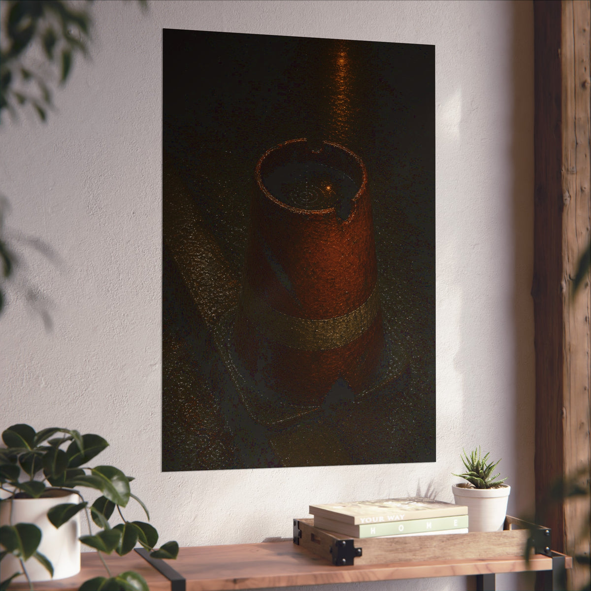An upturned traffic cone holding rainwater at a wet curb under a lamp. The Cup of Rain by Garabaggio, fine art print hanging in a room.