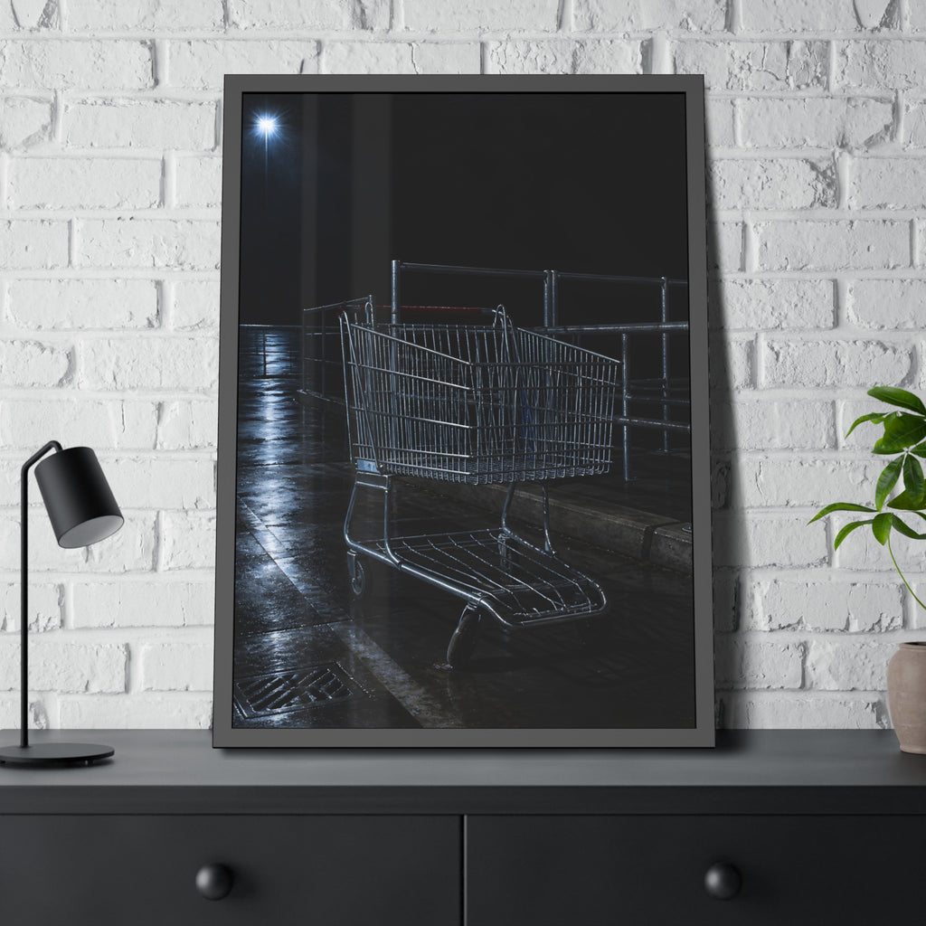 A shopping cart beside its corral on wet asphalt under a lot light. The Cart at the Corral by Garabaggio, framed fine art print hanging in a room.