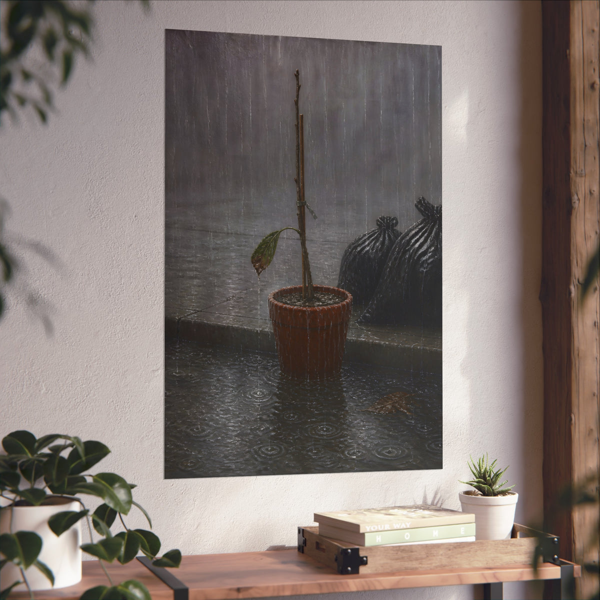 A bare stick in a clay pot on a curb in heavy rain beside trash bags. The Second Rain by Garabaggio, fine art print hanging in a room.