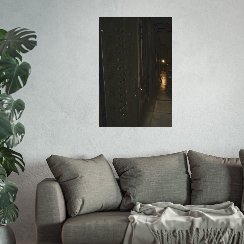 Rows of dark server cabinets with one work lamp glowing far down the aisle. Racks Without Light by Garabaggio, fine art print hanging in a room.