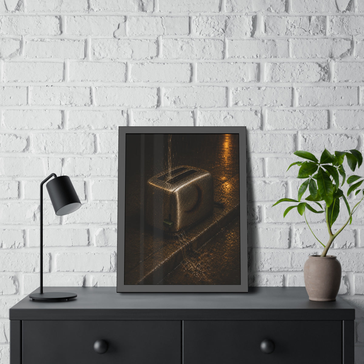 A toaster on a wet curb with water pouring into its slots. Rain Through the Slots by Garabaggio, framed fine art print hanging in a room.