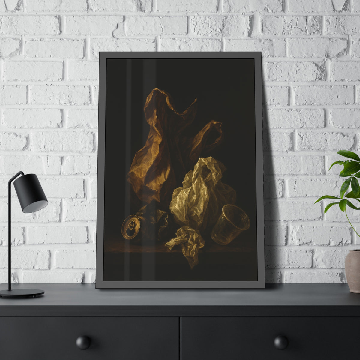 A plastic bag and crumpled paper beside a crushed can and clear cup. The Two Penitents by Garabaggio, framed fine art print hanging in a room.