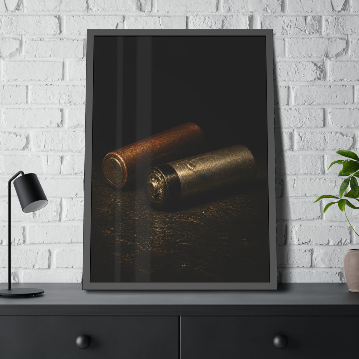 Two spent batteries lying side by side, one rusted, one bare metal. The Second Voice by Garabaggio, framed fine art print hanging in a room.