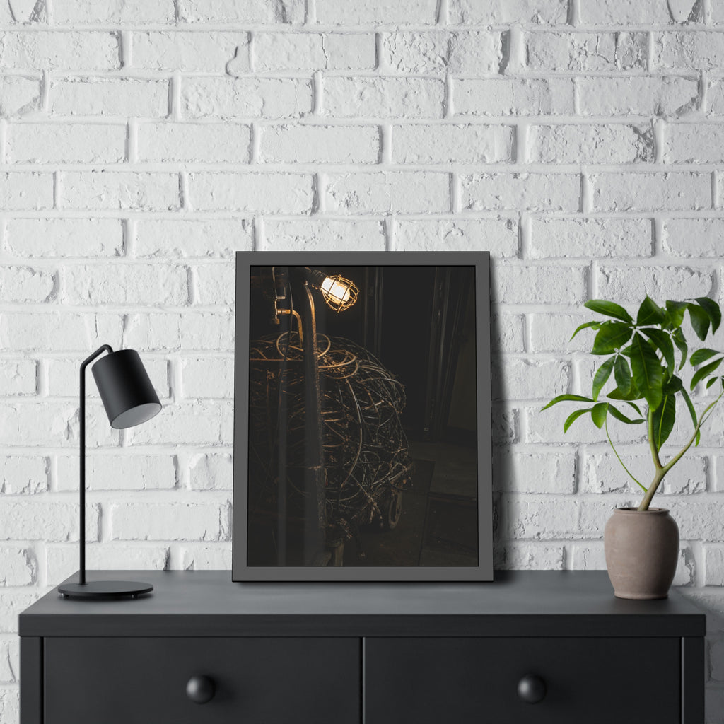 A tangled ball of cables on a hand cart under a caged work lamp. The Cable Harvest by Garabaggio, framed fine art print hanging in a room.