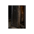 An open server rack cabinet with a mesh door and warm glow inside. The Heat Behind the Doors by Garabaggio, fine art print, 12″ x 16″.