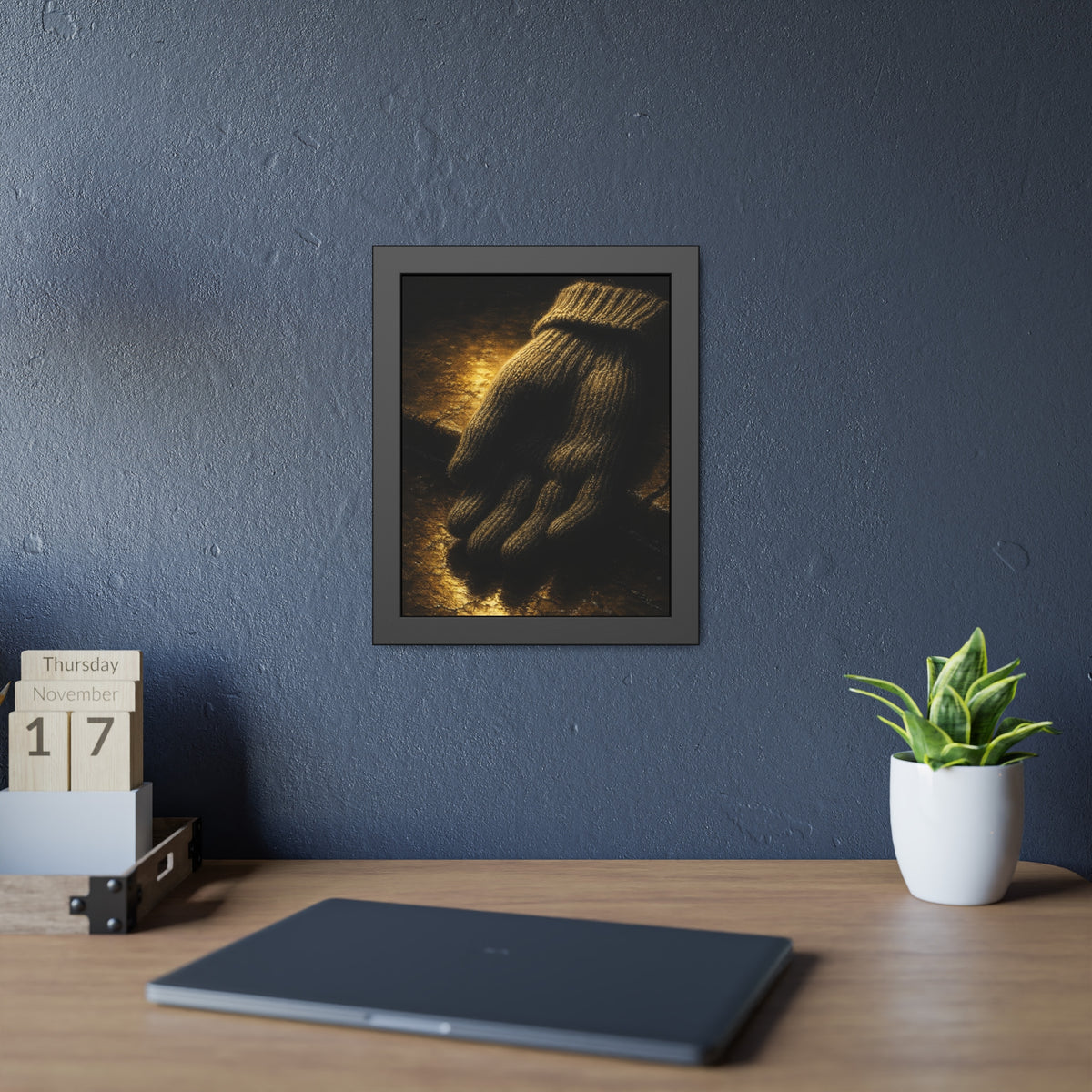 A knitted wool glove palm down on wet stone in gold light. The Presentation of the Woolen Glove by Garabaggio, framed fine art print hanging in a room.